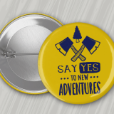 Yellow 1.25 Round Custom Buttons with navy blue imprint featuring crossed hatchets and the text 'Say Yes to New Adventures.