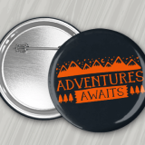 Black 3 Inch Round Custom Pinback Buttons with free shipping, complimentary proofs, and swift turnarounds with orange 'Adventure Awaits' logo