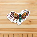 2x4 Inch Die Cut Stickers The photo is a sticker of a moth with colorful wings.