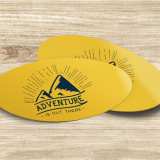 4x3 Inch Oval Stickers This image shows two yellow oval stickers with an image of a mountain that says "Adventure is out there" in black